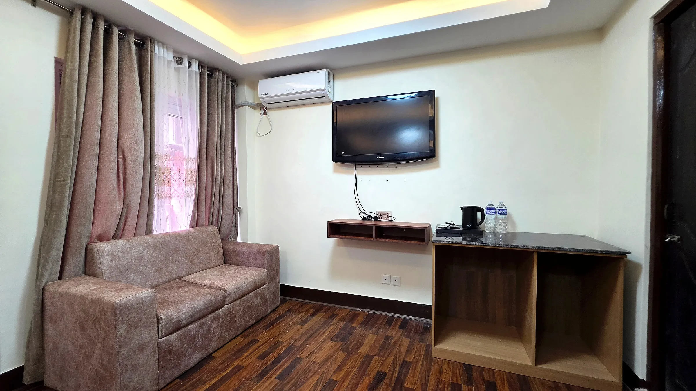 Sitting area with sofa, TV and tea station